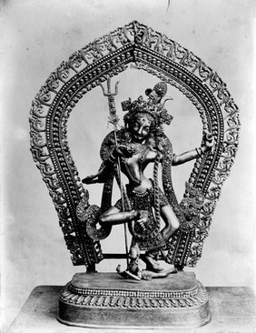 Indian or Persian ornamental statue: figure dancing holding trident.