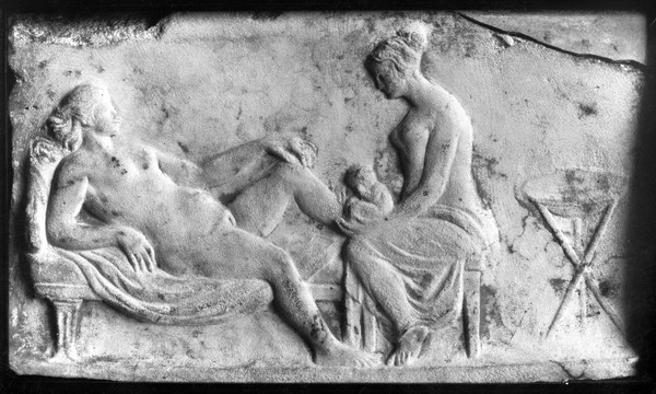 Ancient Roman relief carving of a midwife attending a woman giving birth.