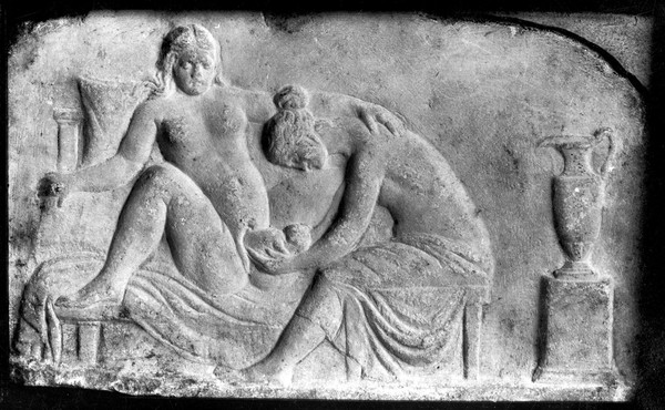 Ancient Roman relief carving of a midwife attending a woman giving birth.