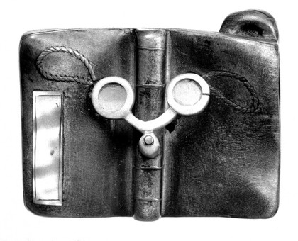 Wood, spectacles on the outside of an opened book. The loops which are attached round the ears are depicted.