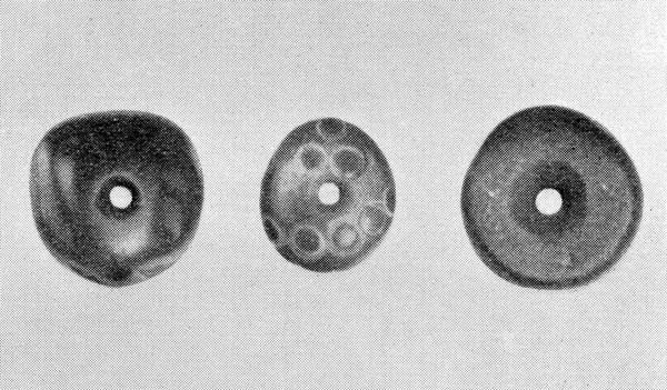 Old grindstone with rainstones at grave of Jada.