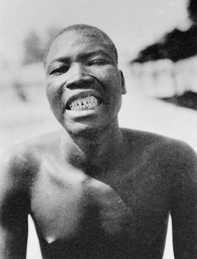 M0005674: A Banara man and a Sara man displaying their teeth