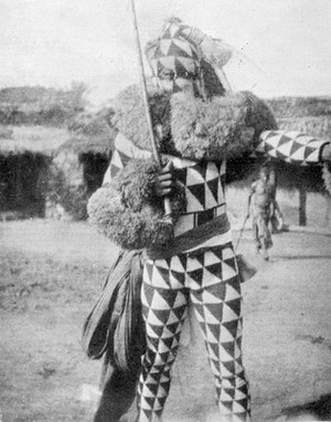 view M0005685: A member of the Ekpe Society in the costume of Ekpe, a spirit who presides at society ceremonies, southern Nigeria