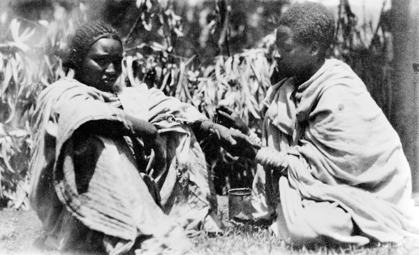 Tatooing in Abyssinia, two women of the Gurag' Tribe. Blue colouring matter is applied in the form of bracelets and rings to the hand and wrist. A needle or small brush is used.