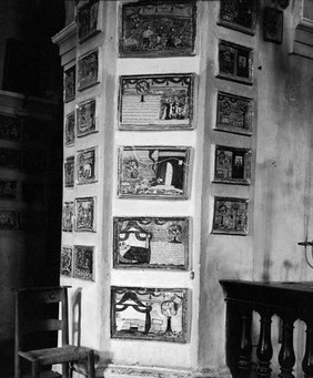 M0007210: View of interior wall showing votive tablets in the Santuario della Madonna dei Bagni, Deruta