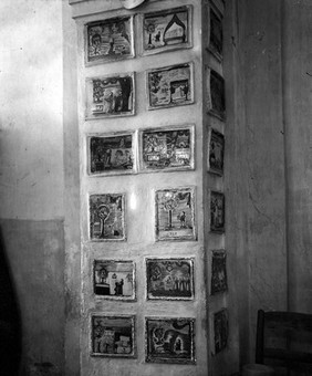 Votive tablets in the Church of Santa Marie de Bagni. Deruta. Pillar showing 18 tablets.