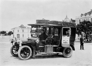 view Wellcome on tour in 1908. Photograph of his car with John Ferreira, courier and interpreter seated inside.