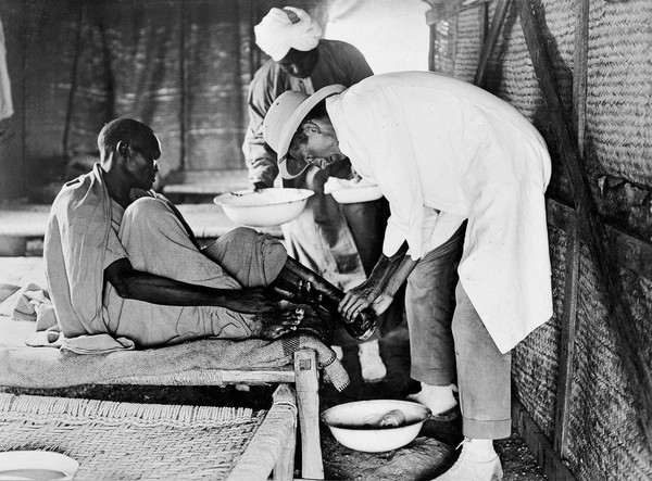 Dr Oldham attending a patient at Jebel Moya, Sudan.