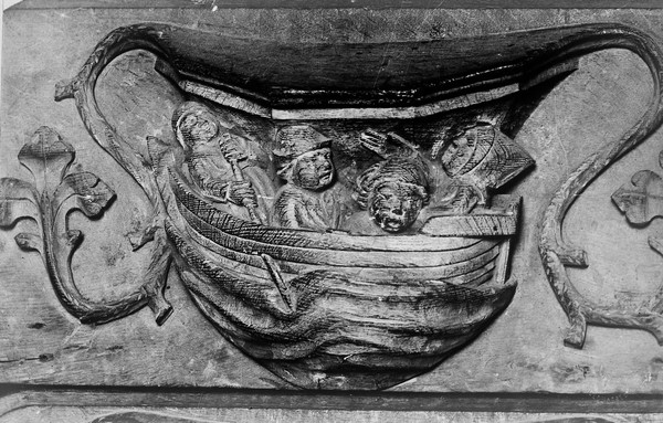 Saint David, sea-sick during his journey to the holy land. Misericord: Saint David's Cathedral.