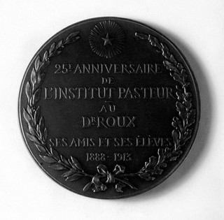 Medal showing bust of Roux