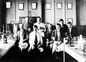 view St. Bartholomew's Hospital, 1896. A group in a laboratory. Seated front-left Earnest Shaw, then T.S.V. Strangeways; in white coat standing A.A. Kanthack, J.W.W. Stephens.