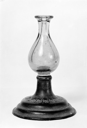 Urn-shaped green glass vessel with metal stand belonging to Dr. J.D. A. Grey, 19 Croftown Road, Ealing, W.5.