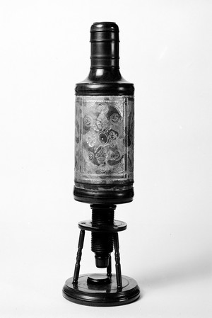 view English compound microscope of the 17th century assigned to Christopher Cock, Optical Instrument maker. Vellum covered body with tripod mount.