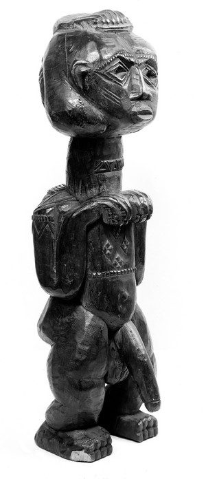 view Male figures with emphasised sexual organs, carved wood. Probably Congo, Africa.