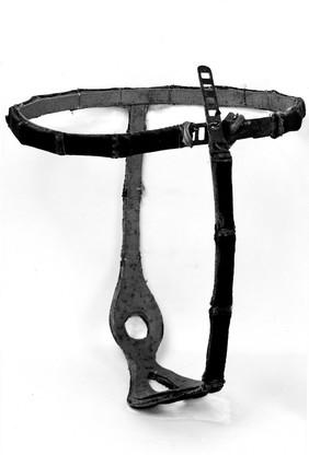 Chastity belt, damascened steel. Design includes scene showing Adam and Eve.