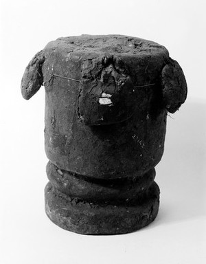 view Cylindrical wooden soum covered with medicine and with four small bags containing power-giving substances. Used for the causation of disease by human agency. Ghana, West Africa.