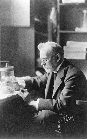 Paul Ehrlich at work in his laboratory, studying an animal