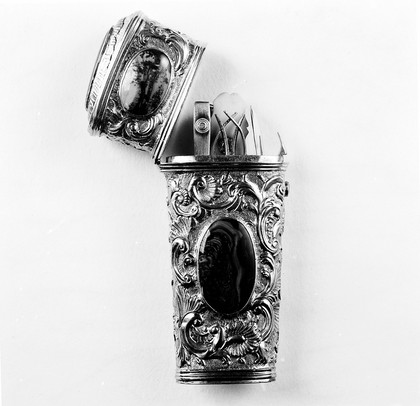 Pocket case containing small toilet instruments. Silver-gilt.