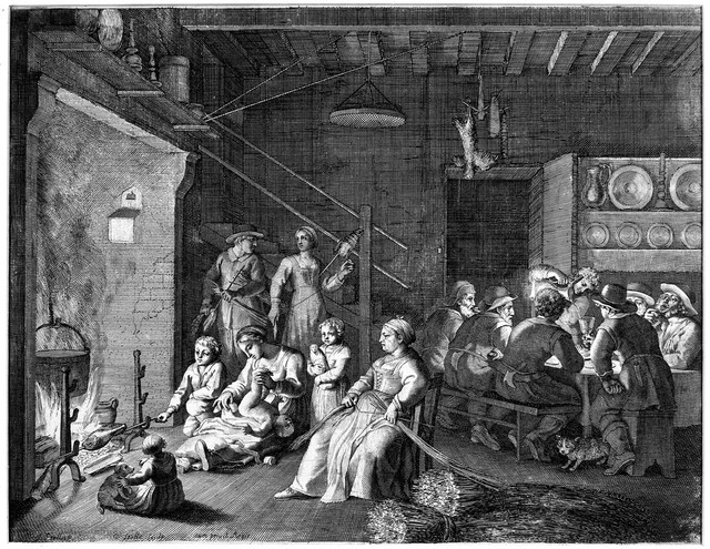 A communal house, the men sit drinking around a table while the women look after the children, weave hay and the older children cook. Engraving by C. Bouzonnet Stella after J. Stella.