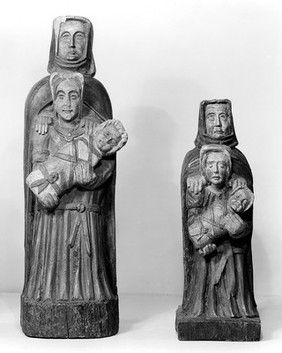 Saint Anne, The Mother of Mary, the Mother of Christ. All three are represented. Invoked by women wishing for children. This form of representation appears to be peculiar to Brittany.