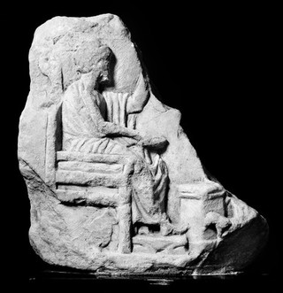 Fragment of a plaque carved in relief; a votive offering.