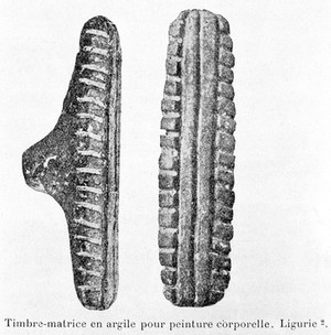 view Neolithic clay stamps for applying design on the body.