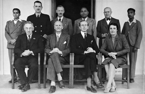 The Medical Mission for Experts on their visit to India: group portrait includes Sir Weldon Dalrymple-Champneys (front row, centre right) and Henry E. Sigerist (back row, second from right). Photograph after a photograph by Kundan Lal, ca. 1950.