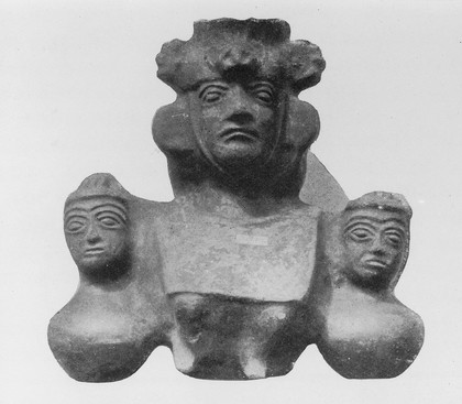 A vase in the form of a seated figure; busts on each side