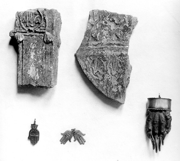 M0016755: Spanish amulets shaped as open hands, fragments of glazed pottery (Andalusian), copper and blue enamel pendant, white metal pendant with Arabic inscription and a badger's hand