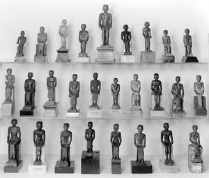 view Collection of figures of Imhotep, Egyptian. Group I, front view. L. to R. R41, 73, 74, 64, 61, 3726, 76, 2948, 52/1936 middle row R4190/37, 79, 2943, 44, 48, 56/1936, R28479, 51, 65, 43/1936 bottom row R47, 53, 77/1936, A190368, 12340, 45, 40, 459/1936