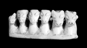 view Amuletic objects of stone to ensure fertility, Bolivia. In the form of a group of animals. Photographed to show their heads.