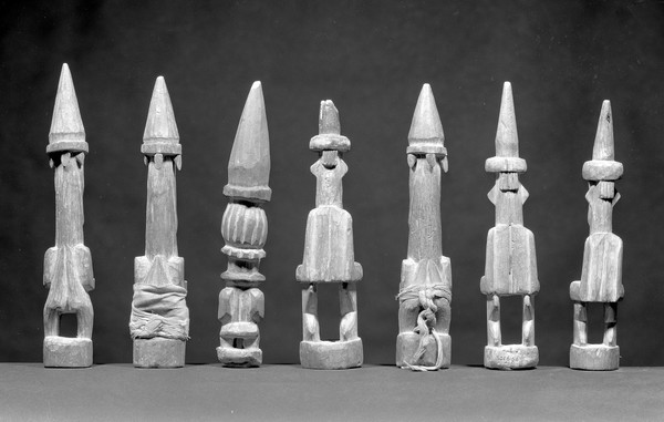 Seven carved wood statues representing Oma, a household god which protectes against sickness and adversity, Yoruba and Isoko, S. Nigeria, Africa [Back view]