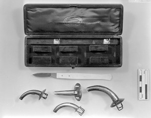 view Surgical Instruments: Tracheotomy tubes and lancet.