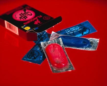 A selection of coloured condoms in their packets