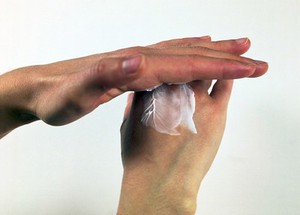 view Woman applying hand cream