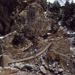 view Nepal; wooden suspension bridge over a canyon