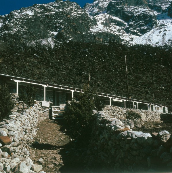 Nepal; Kunde hospital in the Khumbu, 1986. This is the only hospital in the Khumbu region. A 'Visitors Note' at the gate reads: 'Interested visitors may be shown the hospital between 8 am - 5 pm depending on the availability of staff. For this service a donation is appreciated. The hospital depends on donations.' In 1986, the hospital was remarkably well equipped considering its isolation. There were facilities for minor, and in an emergency, major surgery and dentistry, local and general anaesthesia, and an X-ray machine running off its own generator. Some diagnostic facilities were carried out, and the walls of the main clinic were lined with shelves packed with a good supply of drugs, bandages and sutures.