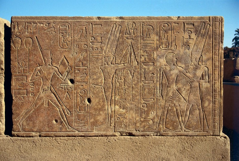 Queen Hatshepsut dancing before a representation of Min