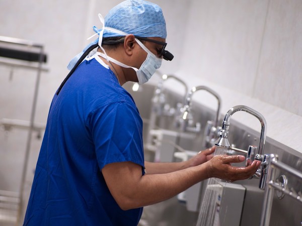 Male surgeon preparing for a procedure.