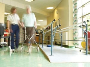 view Female physiotherapist with elderly female patient