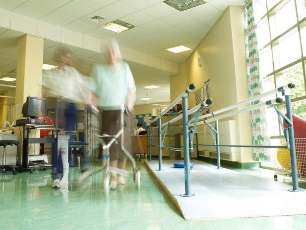 Female physiotherapist with elderly female patient