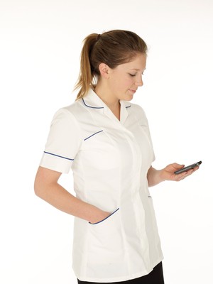 view Young white female health professional in uniform with mobile