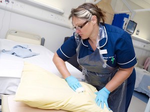 view Nurse carrying out a bed changeover