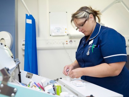 Nurse during a drug administration on a UK hospital ward