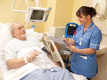 A nurse carrying out observations on a patient