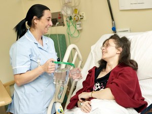 view A healthcare assistant pouring water for a patient