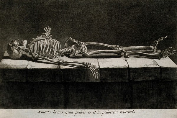 A skeleton, lying supine on a stone slab. Etching by or after J. Gamelin, 1778/1779.