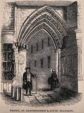 St Bartholomew's Priory, London: the entrance, with a man standing, holding a staff, and a woman walking through the archway. Wood engraving by T. Gilks after W.A.Delamotte.