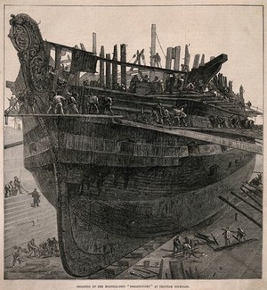 view H.M.S. Dreadnought, a hospital ship, being broken up for salvage at Chatham Naval Dockyard, Kent. Wood engraving, 1875.