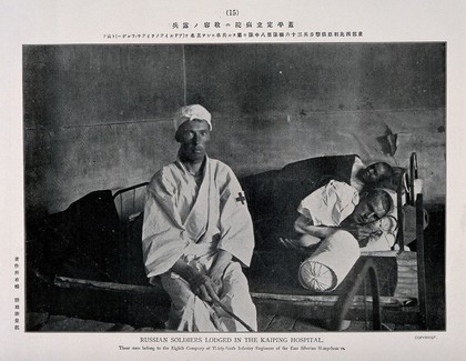 Russo-Japanese War: three wounded Russian soldiers in the Kaiping hospital, two in bed. Collotype, c. 1904.